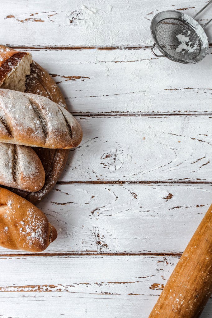 A rustic loaf of bread on a wooden table with a vintage baking ambiance.