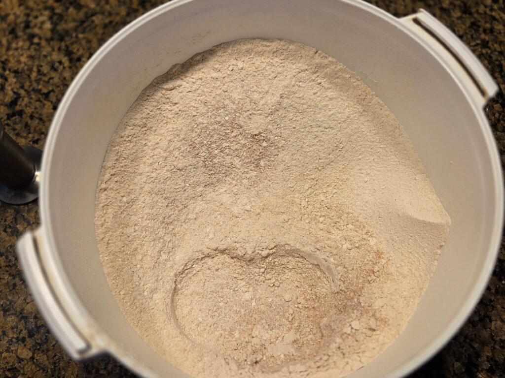 Freshly milled wheat in grain mill bowl