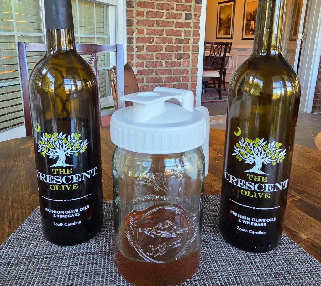 Glass jars of olive oil, vinegar and honey